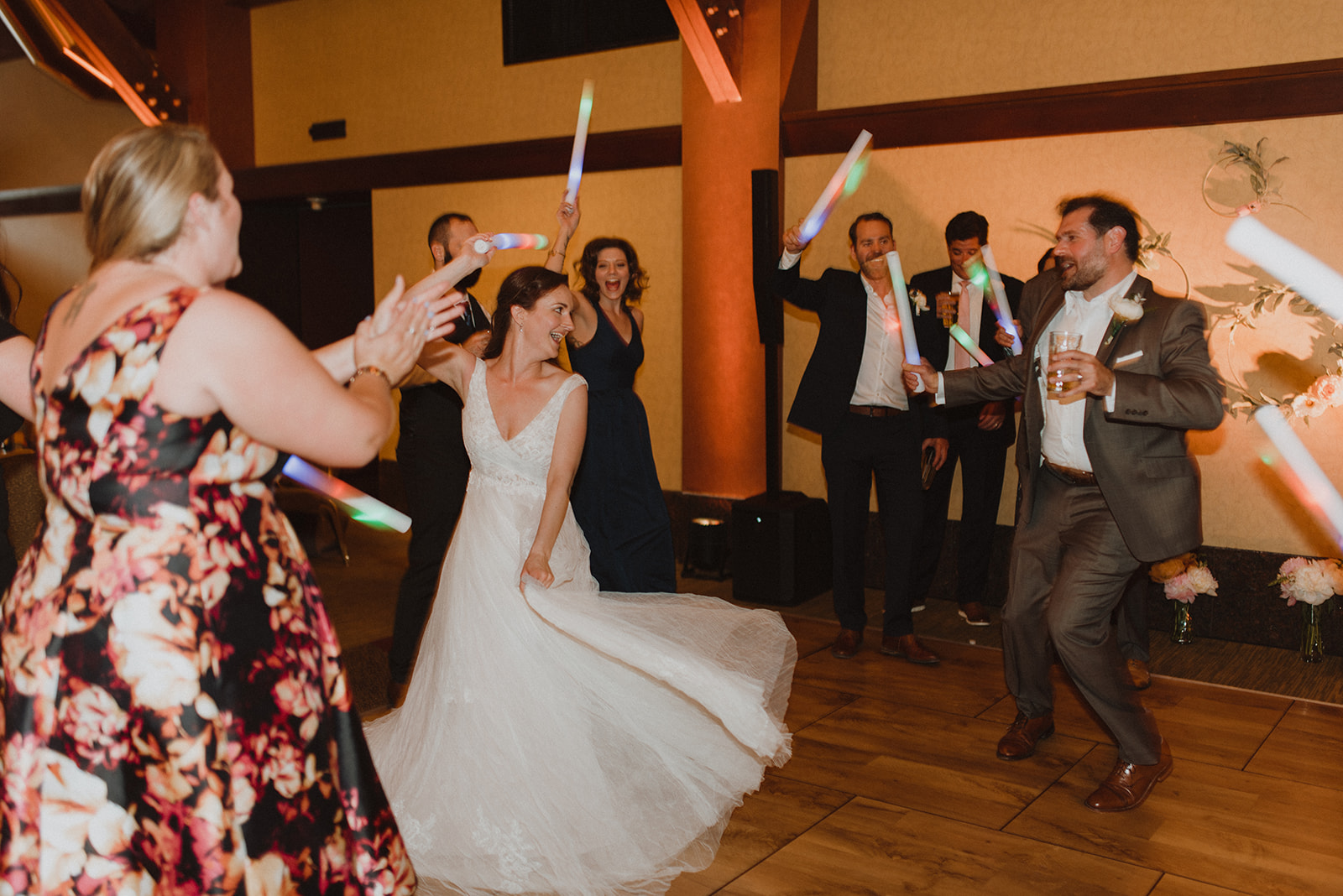 Peter & Victoria Caltagirone Bride dancing as guests wave LED foam sticks on the dance floor at an Alaska wedding reception